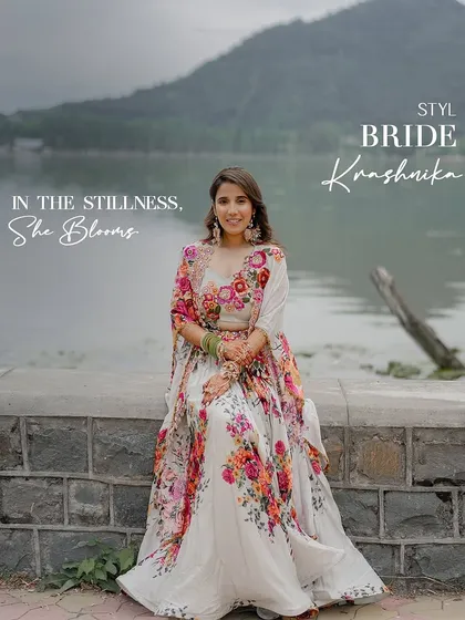 In the stillness, she blooms. For her Haldi ceremony by the Dal Lake, we styled the bride in a stunning floral Gazal Gupta lehenga that felt as fresh and beautiful as the surroundings.