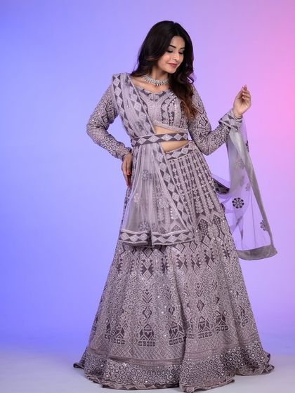 This lilac lehenga features a unique belted dupatta, giving it a contemporary edge while maintaining its traditional charm.