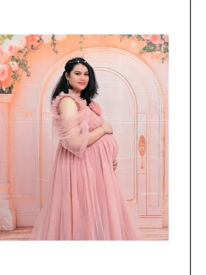 A beautiful solo portrait where the mom-to-be is wearing a delicate headband that complements her pink gown and the floral setting. It's these little details that make a photoshoot special.