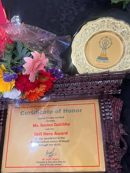 A photo of the 'Skill Hero' award, certificate, and flowers I received. This recognition from Glocal Private Limited for my work in Nepal's arts and culture sector was a true honor.