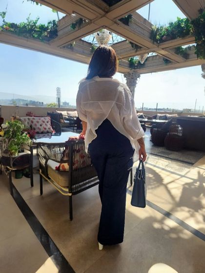 The back view of the asymmetrical white shirt, showing how an unconventional silhouette can add personality and create an 'aspirational distance' that invites attention.