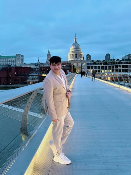 An evening stroll on the Millennium Bridge in London, with St. Paul's Cathedral in the background. The city's twilight ambiance is truly magical.