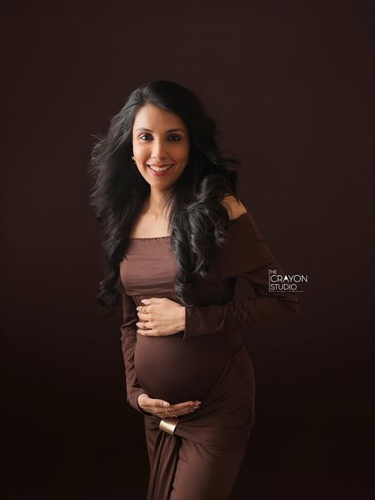 A bright, happy smile contrasts beautifully with the moody, dark background. This portrait shows that fine art photography can be both elegant and full of joy.