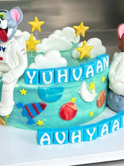 Tom and Jerry are heading to space! This fun, custom-themed cake features the iconic duo in astronaut suits, surrounded by planets, stars, and clouds for an out-of-this-world birthday.