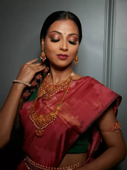 The elegance of a South Indian bride. This look features classic elements like a winged eyeliner, a deep red lip, and beautifully defined brows, all working together to enhance her natural beauty.