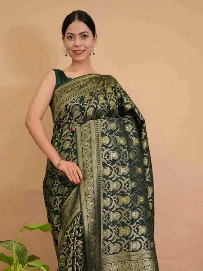A classic Banarasi-style 1-minute saree in a deep bottle green with intricate gold zari work. This pre-stitched saree provides a regal and timeless look, perfect for weddings and festive celebrations.