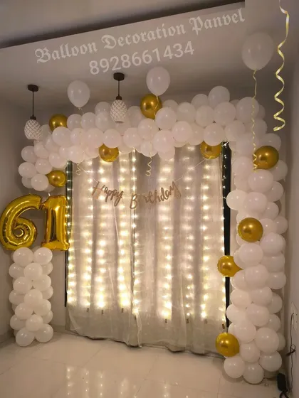 A duplicate view of the classy 61st birthday decoration, showcasing the beautiful combination of white and gold balloons with warm lighting.