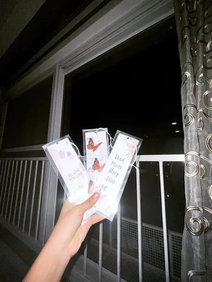 A nighttime shot of the custom bookmarks, showing how they catch the light. Each one is a small piece of art to mark your page.