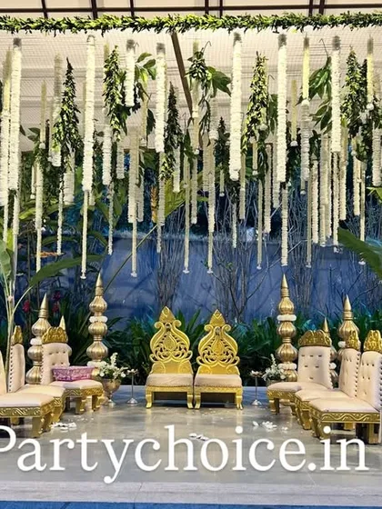 This is a close-up of a modern yet traditional mandap design. We used hanging garlands of white tuberoses and green foliage against a gazebo structure, flanked by banana plants to blend contemporary style with classic wedding elements.