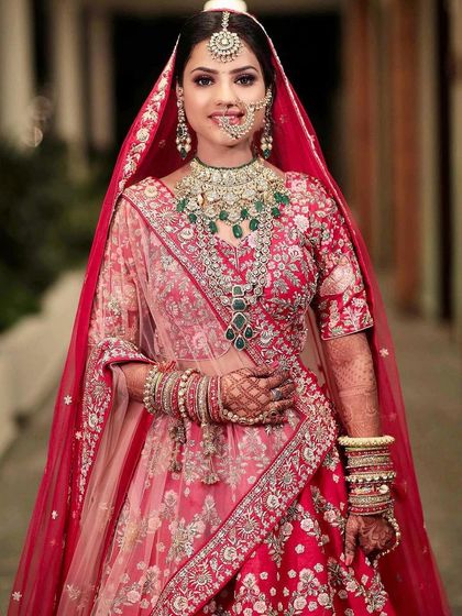My NG bride looking absolutely stunning. I love the combination of her red lehenga with the beautiful green jewellery.