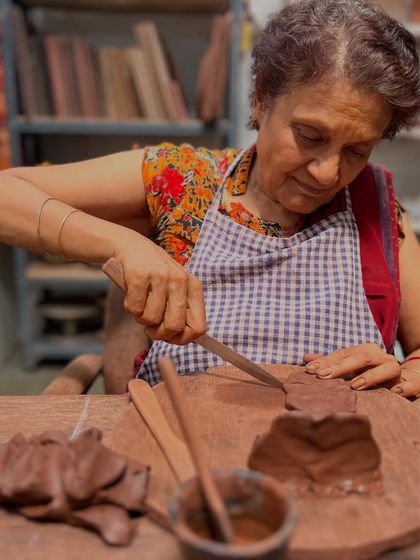 Here is my mother, deeply focused as she carves details into the clay temple she is building. The studio is a space for all generations to explore their artistic side.