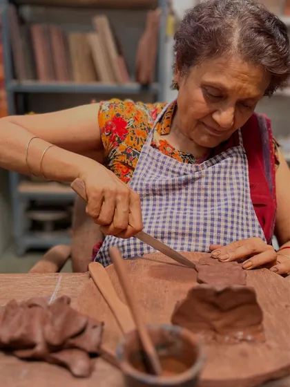 Here is my mother, deeply focused as she carves details into the clay temple she is building. The studio is a space for all generations to explore their artistic side.
