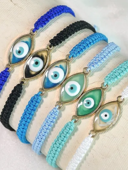 This collection of evil eye rakhis features a braided band design in a variety of beautiful blue and green shades.