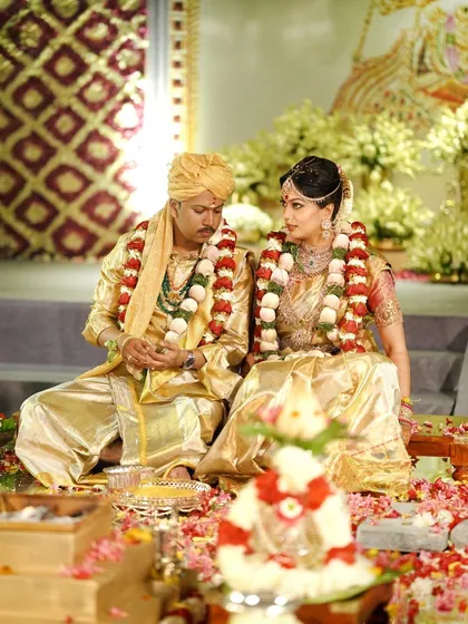 A candid moment of the couple during the wedding ceremony, seated within the magnificent temple setting we created. The grandeur of the decor provides a timeless and regal backdrop for their union.