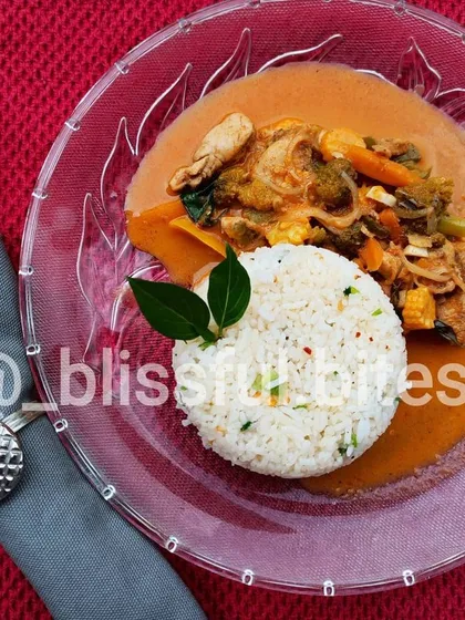 My beautifully plated Thai Red Curry with herbed garlic rice. This dish shows my versatility, offering a creamy, coconut-based curry with chicken and vegetables for those who enjoy international flavours.