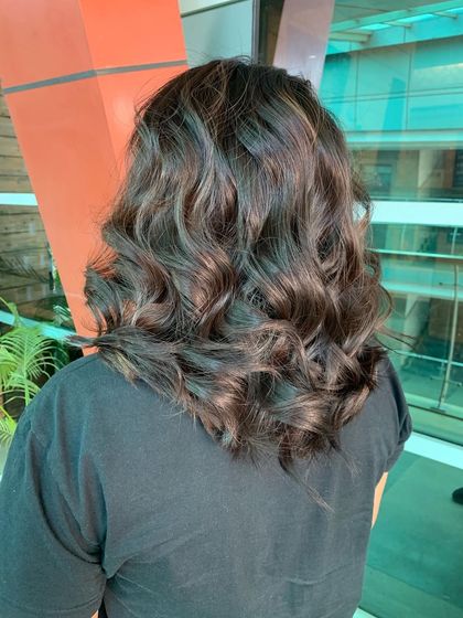Another angle of the soft balayage, this photo highlights how the gentle waves and subtle color work together. This look is perfect for adding dimension without a drastic change.