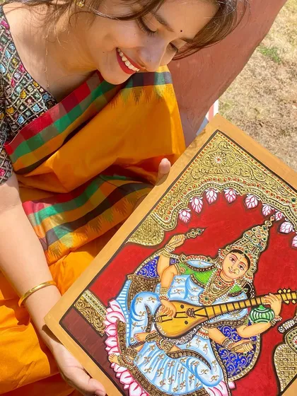 Admiring the final details of the traditional painting.