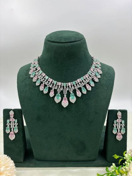A delicate silver-plated AD necklace with a fringe of leaf-shaped stones. This design is available in mint green, white, and a two-tone pink and green, offering a fresh and modern aesthetic.