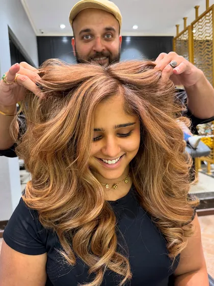 A warm-toned hair colour balayage with beautiful blonde and caramel highlights.