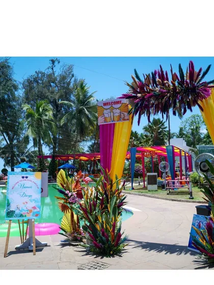 A poolside party with a tropical carnival theme. I used bright foliage, flamingo props, and colorful signage to create a fun, vacation-like vibe for this pre-wedding celebration.