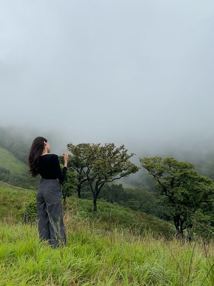 A solo traveler enjoying the misty landscape of Netravathi.