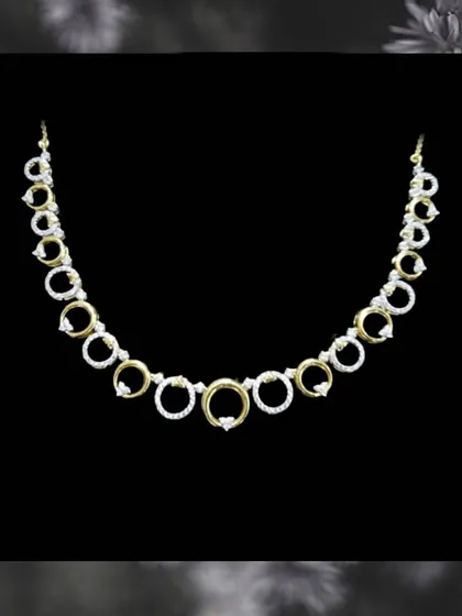 This modern necklace features circles of gold and diamonds, creating a chic and contemporary look. It is another example of our elegant, budget-friendly options.