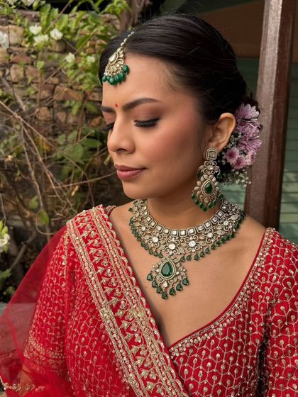 A side profile of the bride, showcasing the soft smokey eyes and the beautiful floral hair accessory. This highlights how every detail, from makeup to hair, comes together to create a cohesive bridal look.