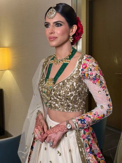 A happy bride showing off her classic red rose bun, a timeless choice for any wedding ceremony.