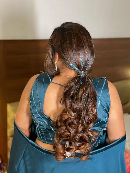 For this sangeet, I created a fun and glamorous ponytail with a side braid. The addition of glitter strands in the hair adds that extra sparkle for a night of dancing.