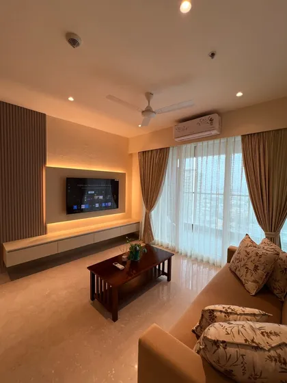 This TV unit is designed to be both stylish and functional. It features a floating console for a light feel, integrated backlighting for ambiance, and a fluted wood panel to add texture and architectural interest.