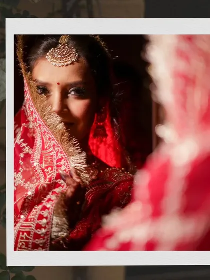 An artistic shot of a bride looking into a mirror, with her reflection creating a sense of depth and introspection.
