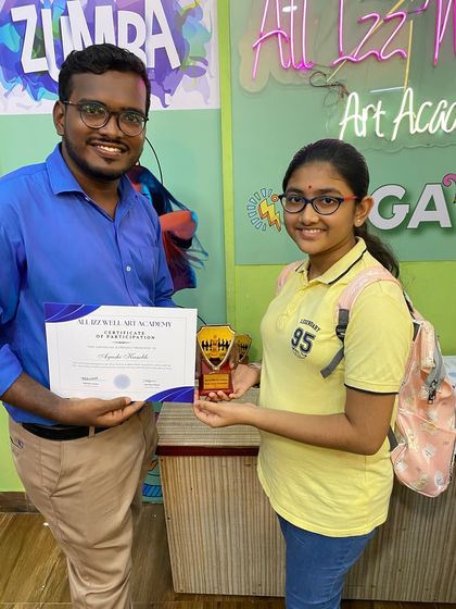 Ayushi Kamble proudly accepts her participation award at our recent chess tournament. Well done!