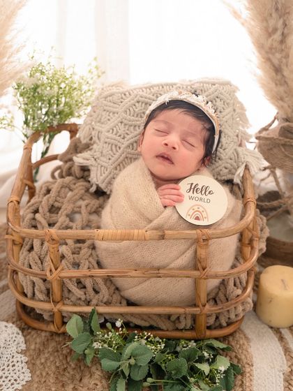 Announcing her arrival with a "Hello World" sign, this little one is the star of her boho-chic photoshoot.