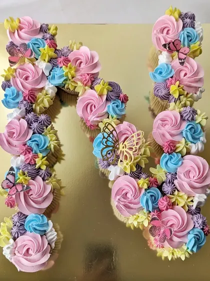 A pull-apart cupcake cake in the shape of the letter 'N'. This is a great alternative to a traditional cake, as guests can just grab a cupcake.