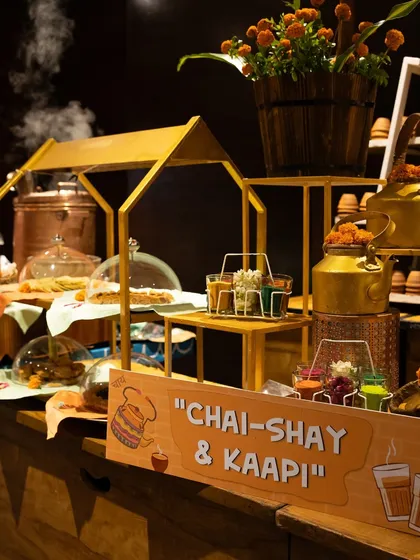 Our "Chai-Shay & Kaapi" corner is a tribute to India's favourite beverages. With traditional kettles and a steaming pot, we serve comforting cups of tea and coffee, perfect for any time during the celebration.