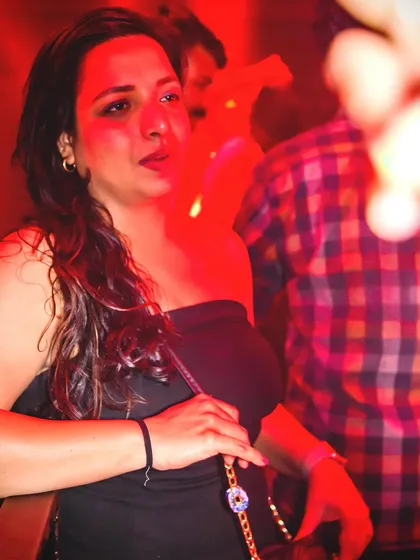 A candid shot of a guest in the red-lit ambiance.