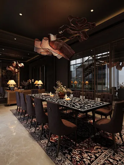 A view of the moody dining room, showing its connection to an outdoor space through large glass windows. This provides a contrast between the dark interior and the light-filled exterior.