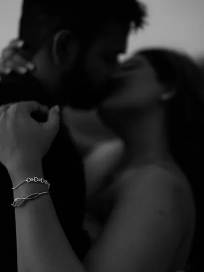 An intimate, blurry kiss in black and white. This artistic shot focuses on the connection and the moment of passion, creating a feeling of intimacy and romance.