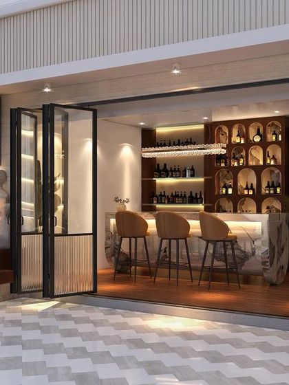 The centerpiece of this Gurugram terrace is the indoor-outdoor bar, revealed by folding glass doors. We designed this space for high-end entertaining, with a fully stocked bar and comfortable seating that flows onto the patio.