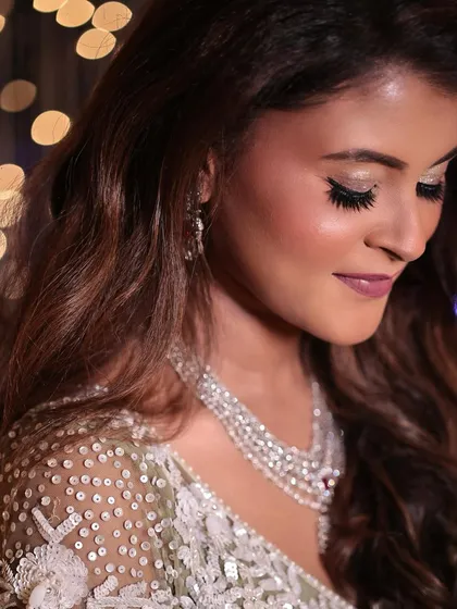 A close-up of a Sangeet bride's makeup. The look features soft, shimmering eyeshadow and a beautiful mauve lip color.
