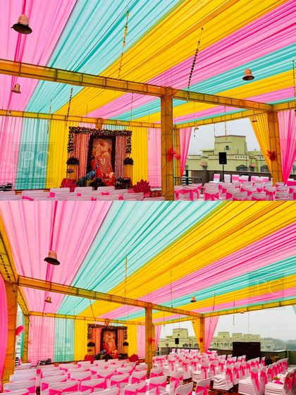 My decor services are not just for weddings. This is a large-scale tent and seating arrangement I managed for a 'Guruji' event, using bright drapes and clean white chair covers to create a serene and organized space.