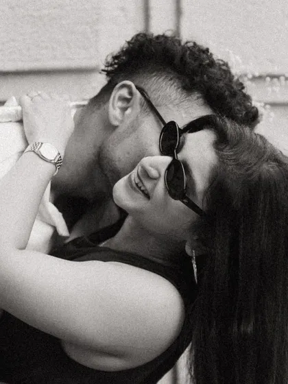A cool and casual black and white portrait of Alicia and Jeff. The sunglasses and close embrace give this pre-wedding shot a chic, modern, and effortlessly romantic vibe.
