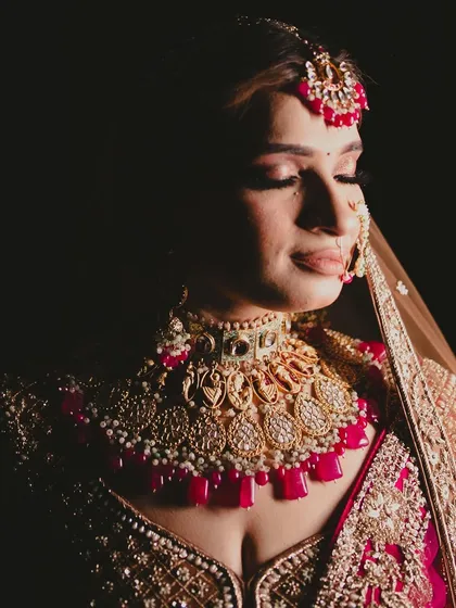 A dramatic, shadowed portrait highlighting the incredible detail and sparkle of this royal bridal necklace.