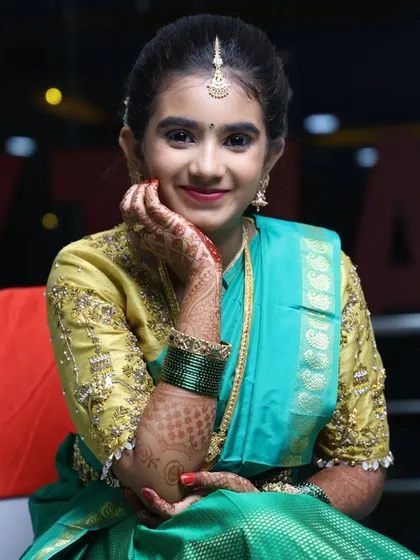 I love doing makeup for half-saree functions. For Niharika, we chose a youthful and fresh look with glowing skin and pretty pink lips to match her beautiful traditional outfit.