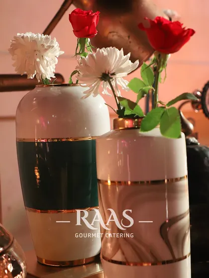 Attention to detail is key to my service. I use elegant decor elements like these beautiful vases with fresh flowers to enhance the overall look and feel of the buffet area.