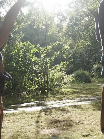 Two students practicing handstands outdoors during a Flow Fest. Nature provides a beautiful and inspiring backdrop for our training.