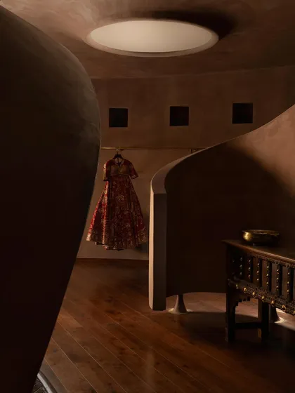 The path through the store is a winding discovery, with garments revealed in niches and alcoves.