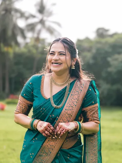 A candid portrait of a bride laughing in a beautiful outdoor setting. Her natural joy is the focus of the shot.
