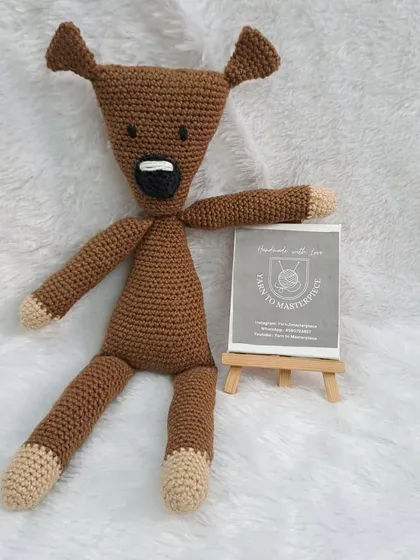 A close-up of the Mr. Bean's Teddy that was part of a larger baby gift hamper.