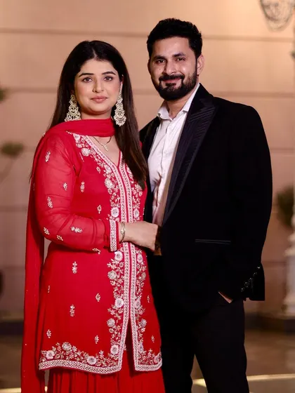 Creating a harmonious look for couples is one of my passions. For her, I designed a soft, romantic makeup style with glowing skin and defined eyes to complement her beautiful red ethnic suit. This ensures she looks radiant and picture-perfect for their special event.